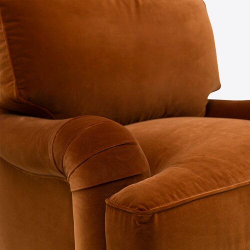 Rust velvet traditional armchair on castors